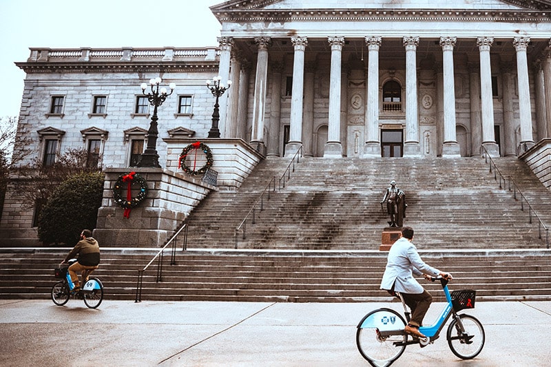 Two cyclists riding around at the capital building in Columbia, SC