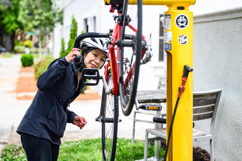 Woman using CTBC Bike Repair Stand in Columbia