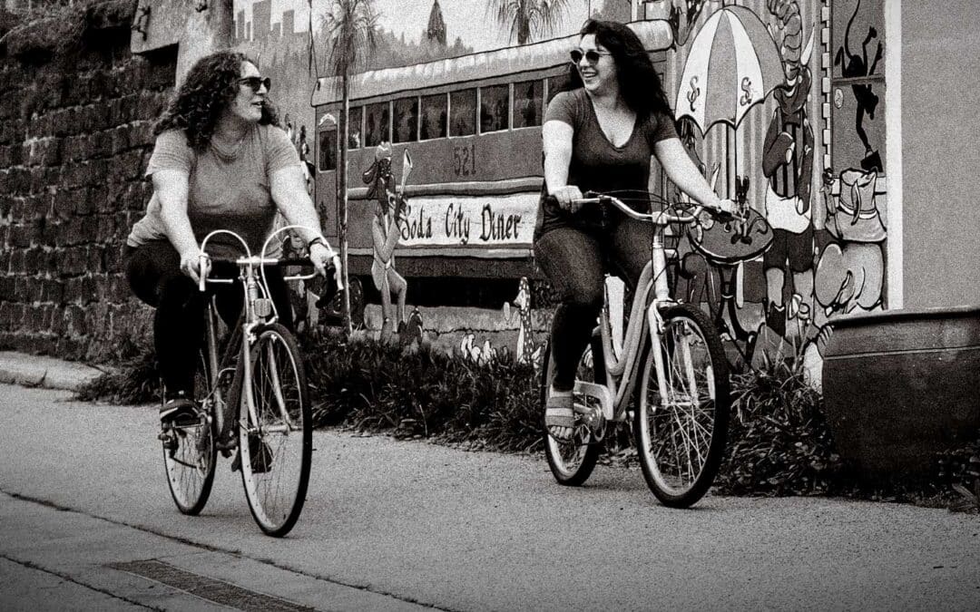 Two women riding bikes in downtown Columbia
