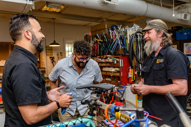 Karl, David, and Scott working in the bike shop