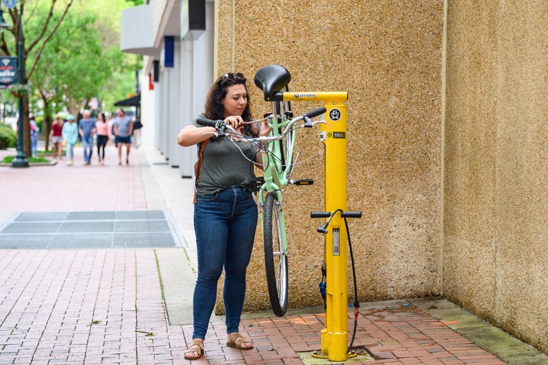 Woman using bike repair stand in Columbia