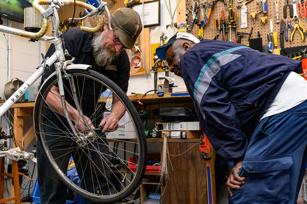 Scott working with a client on a bike repair